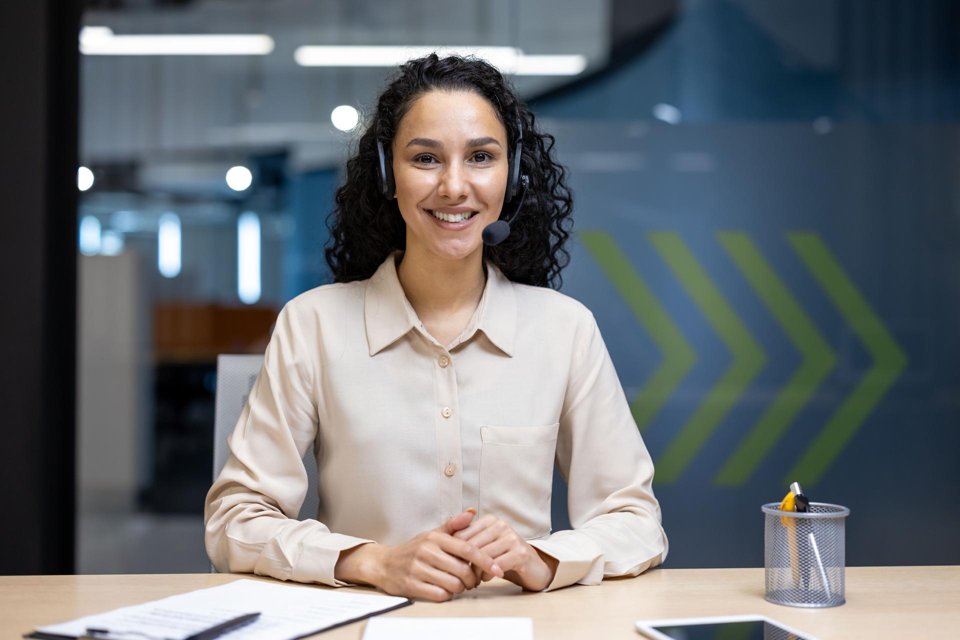 Friendly female customer service representative at modern office workspace
